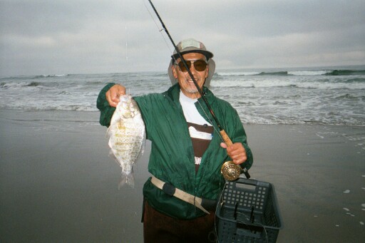 Glenn with nice barred perch in front of the water where it was caught.